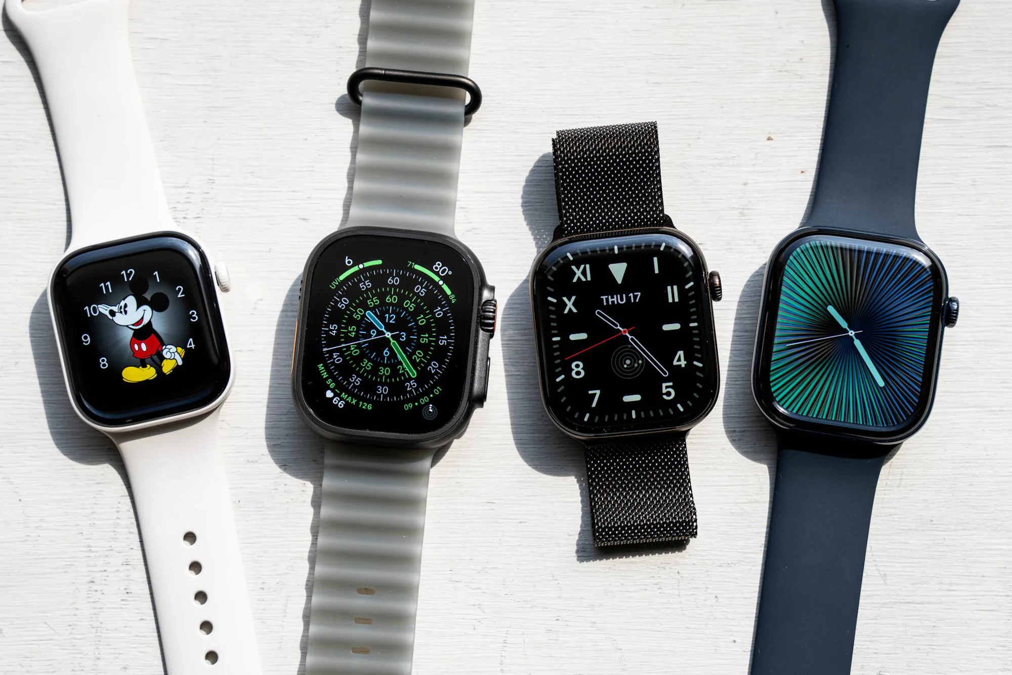 4 Apple Watches next to each other.