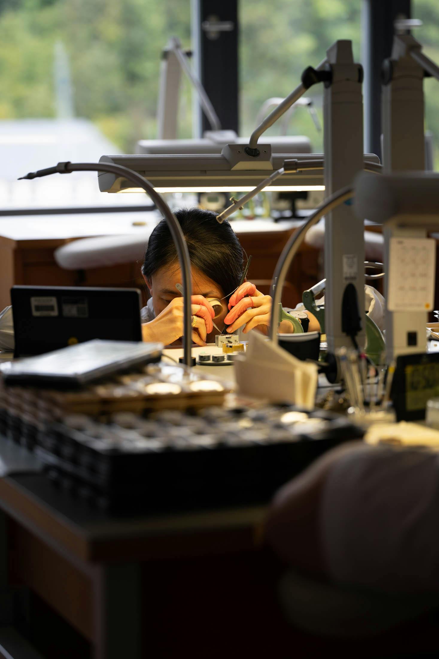 watchmaker at her desk