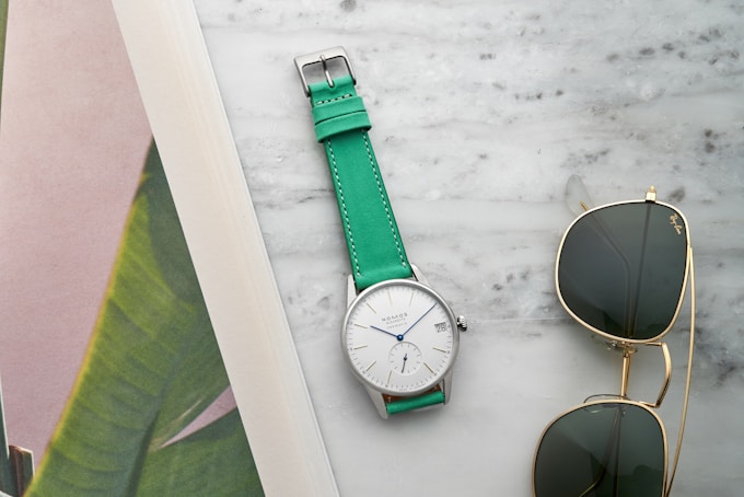 The NOMOS Orion Neomatik 41 Date paired with a HODINKEE Bedford strap in mint green.