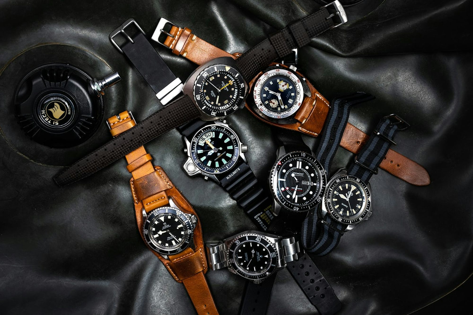 A pile of watches on a black background