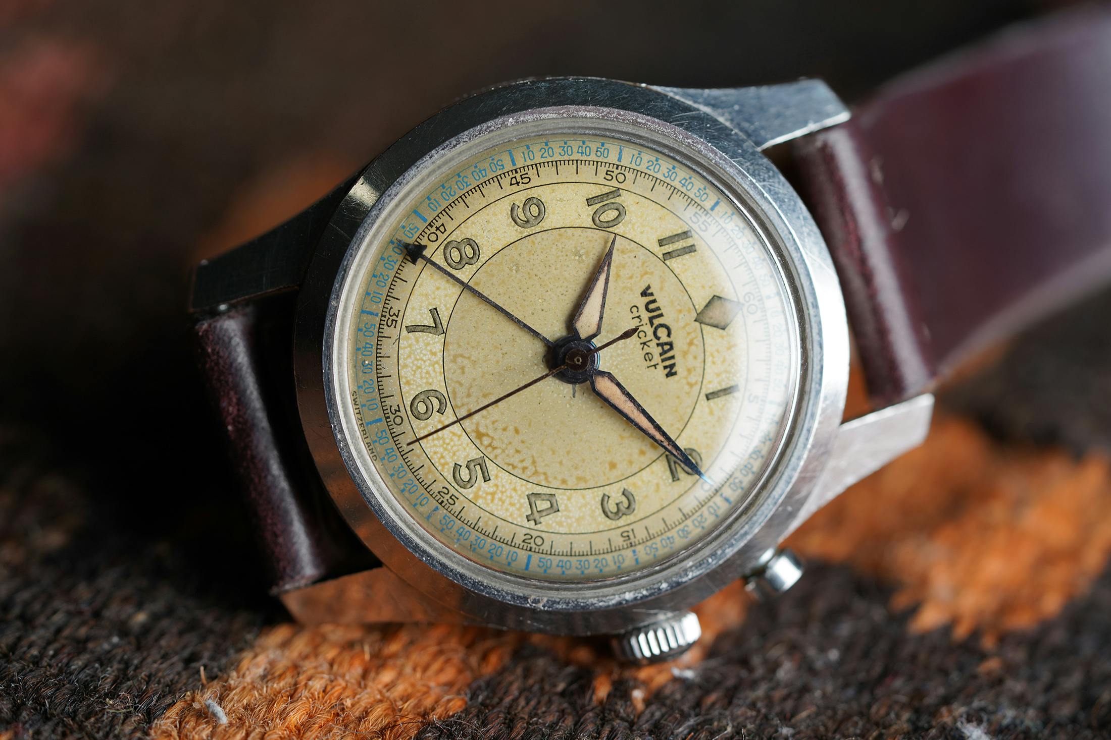 A Vulcain cricket watch on a leather strap