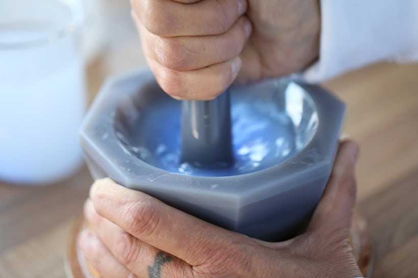 Grinding enamel powder in a mortar and pestle