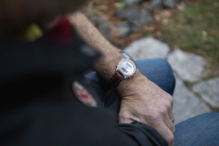 A white dial watch on a wrist