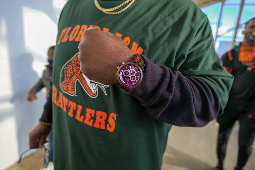 A man wearing a purple watch