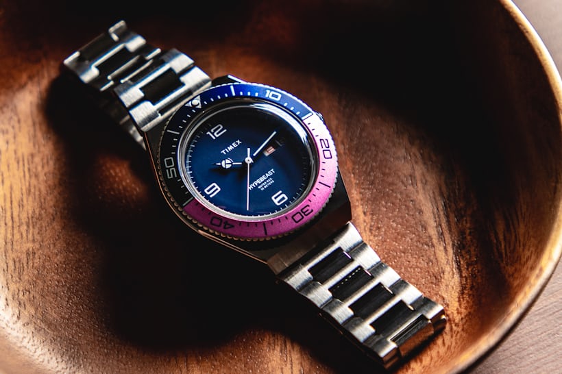 A three-quarter angle of the Timex M79 Fuchsia Limited Edition laying in a bowl.