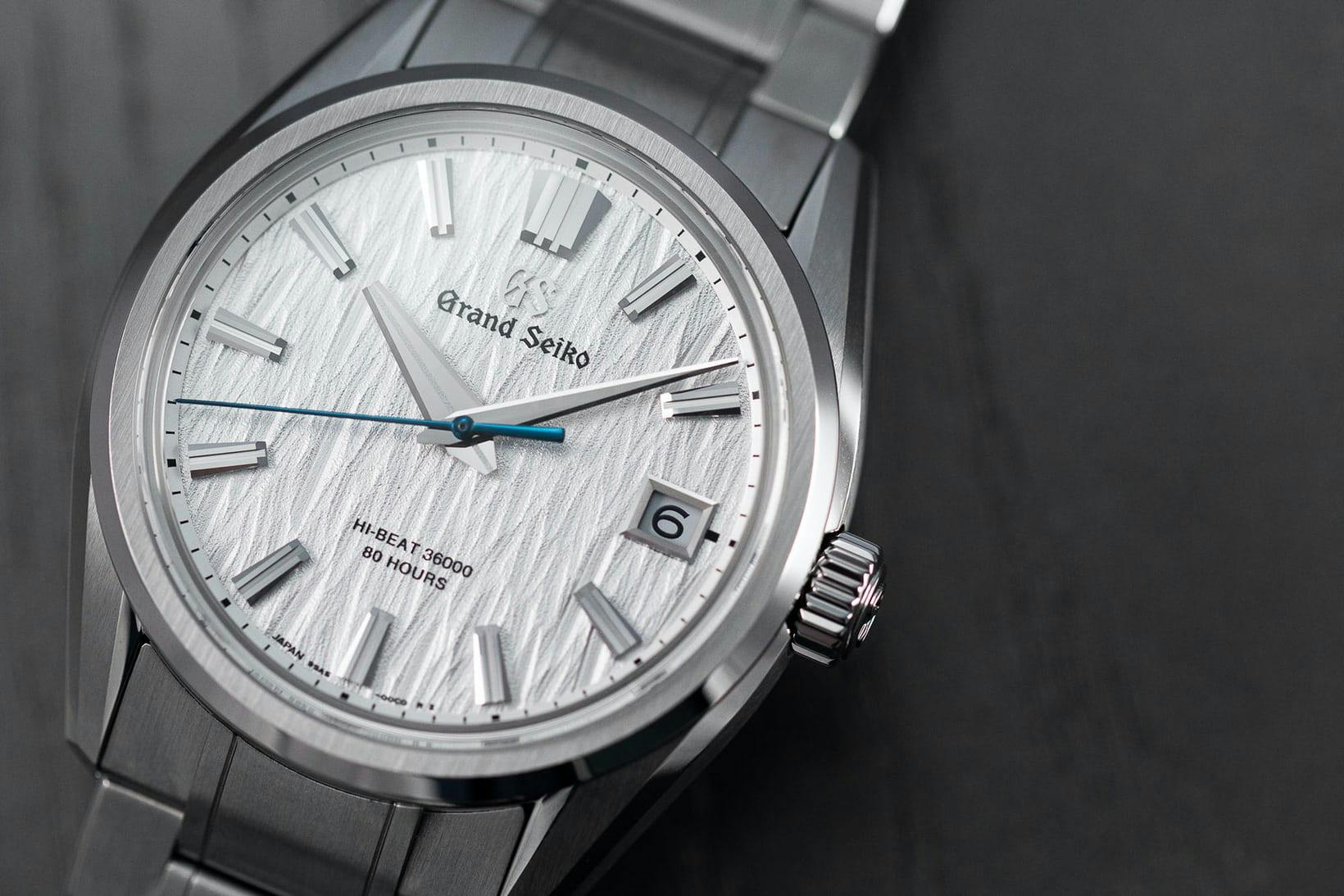 A Grand Seiko "White Birch" watch on a black background