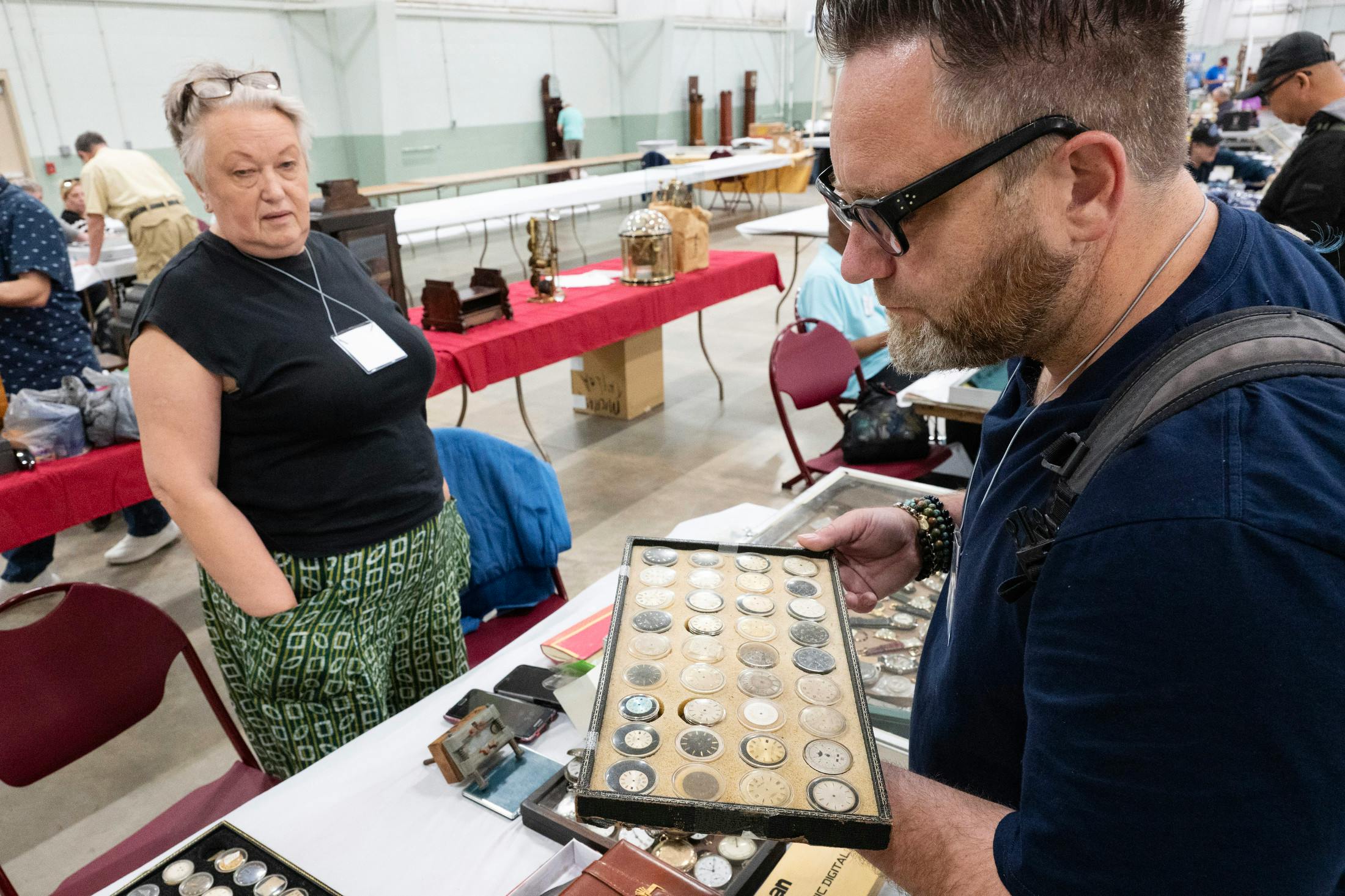 Scotty Signor browsing through some wristwatch dials.