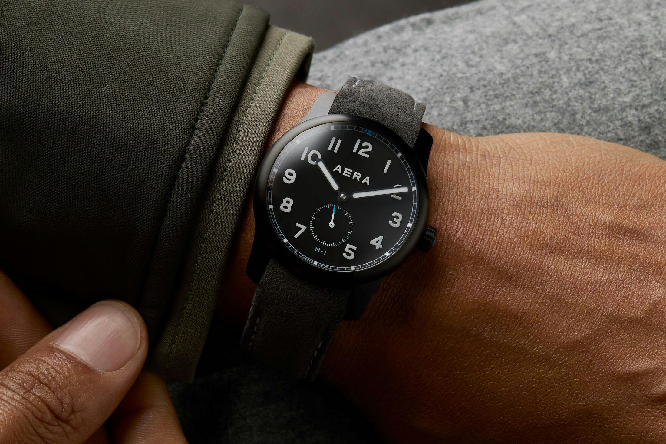 m-1 watch on rock background