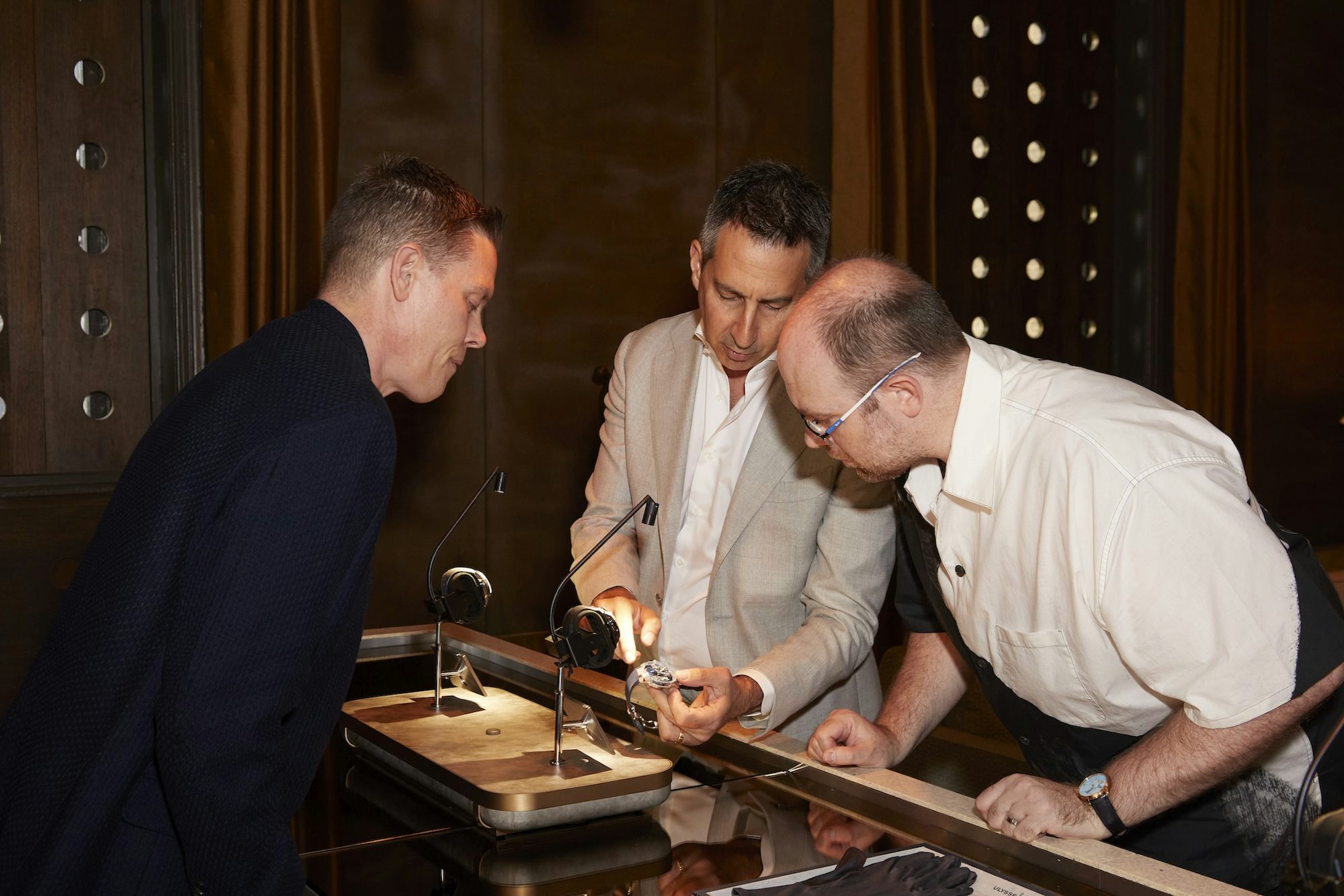 3 Men looking at watches