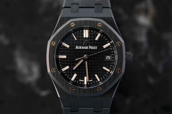 A black Royal Oak watch on a black background