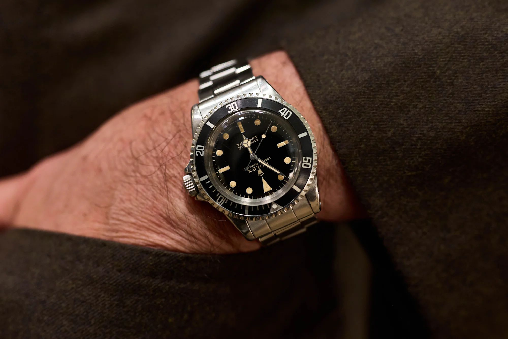wearing a Rolex Submariner Ref. 5513 with gilt dial