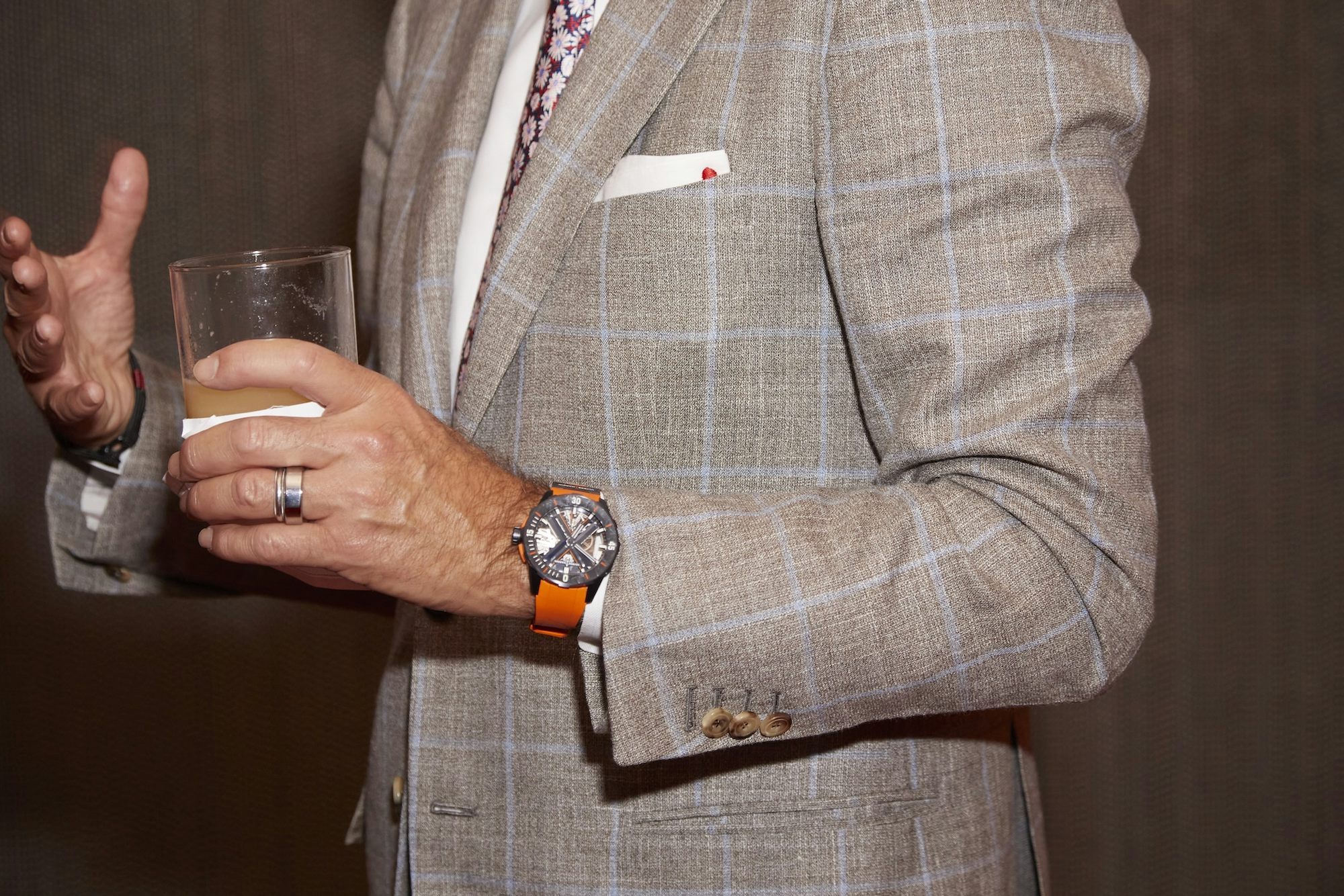 a man in a suit wearing a Ulysse Nardin watch