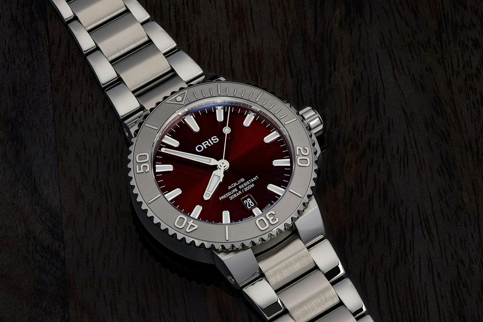Oris Cherry Aquis watch on a black background