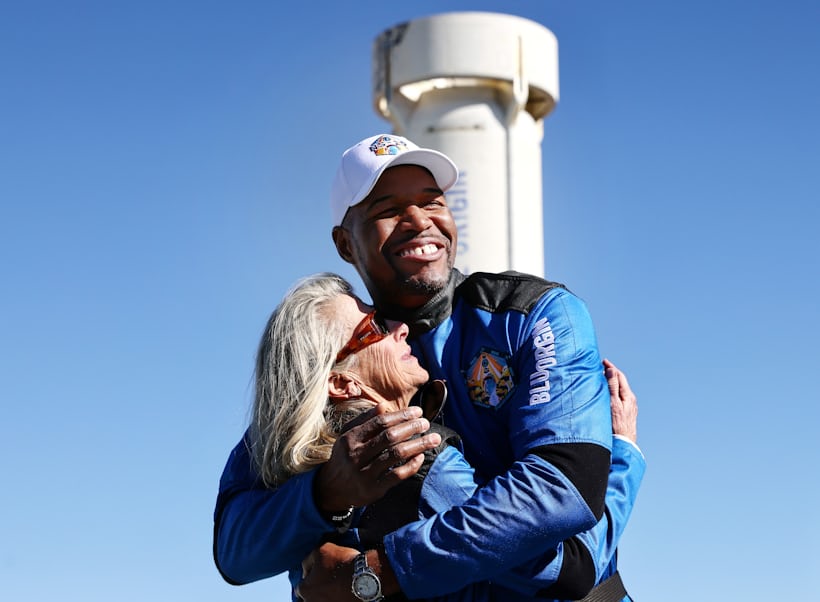 Strahan hugs Laura Shepard Churchley with his Rolex GMT-Master II visible on his wrist.