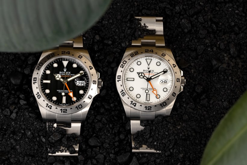 Two Rolex watches one with a black dial and one with a white one