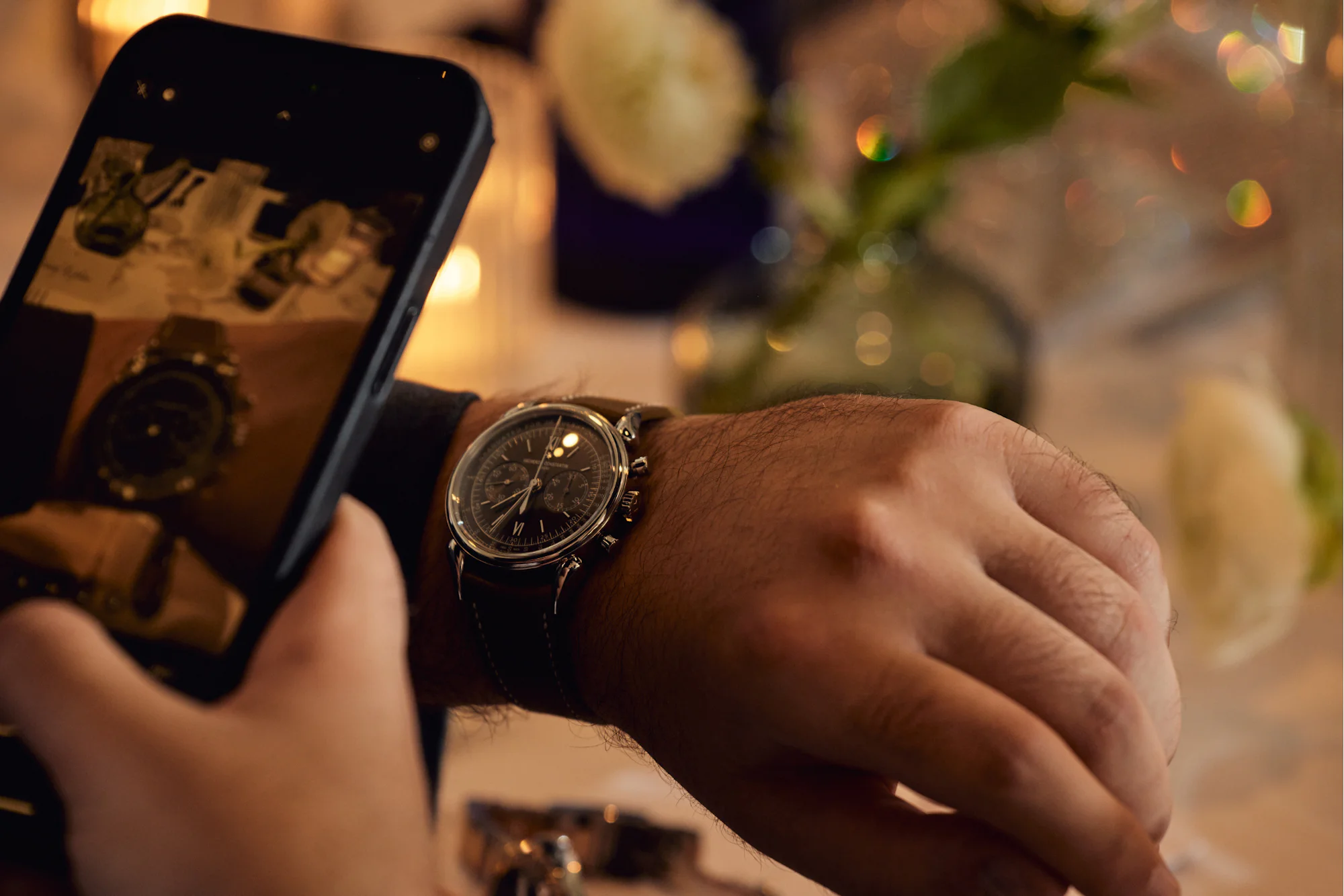 Guest taking an iPhone photo of watch on wrist