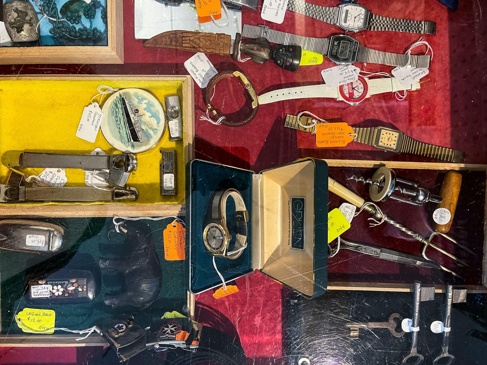 A cabinet with several vintage watches. 