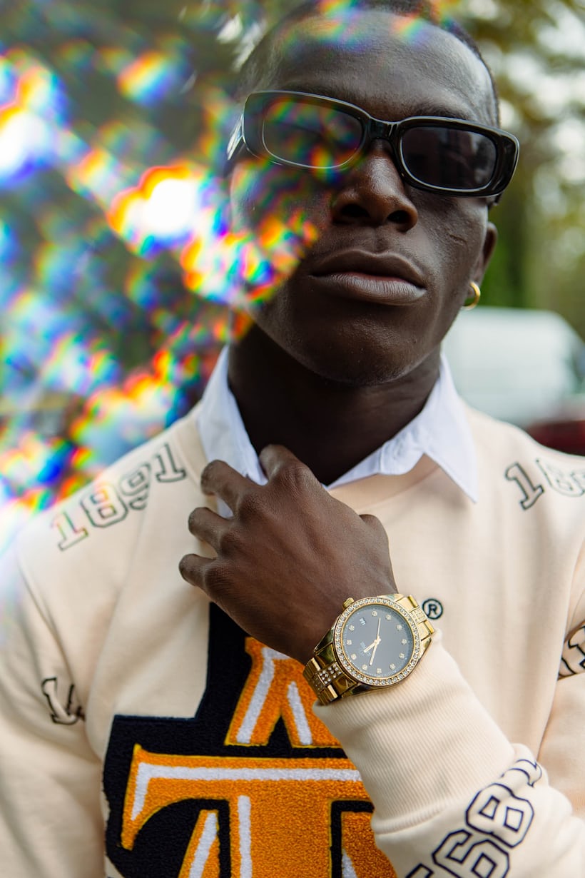 A person wearing a watch and sunglasses