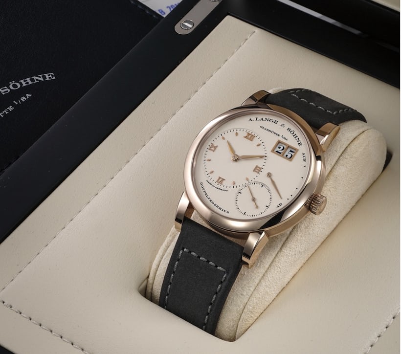 A honey gold Lange 1 laying in a watch box.