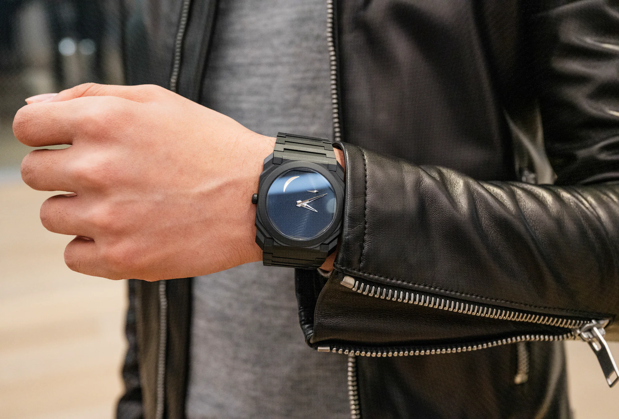 A man in a leather jacket wears a Bulgari Octo Finissimo Tadao Ando