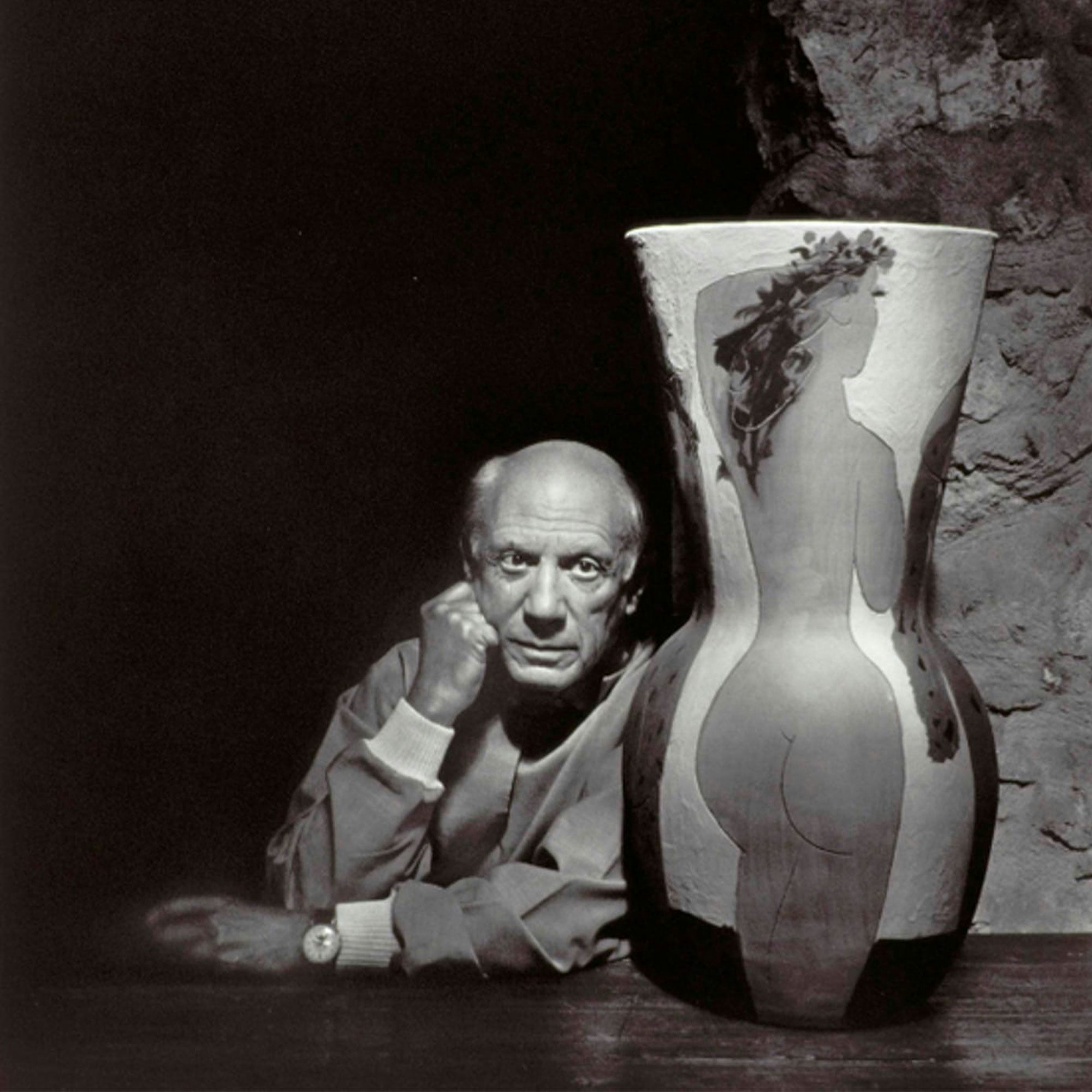 Pablo Picasso poses next to a vase, wearing a Jaeger-LeCoultre triple calendar.