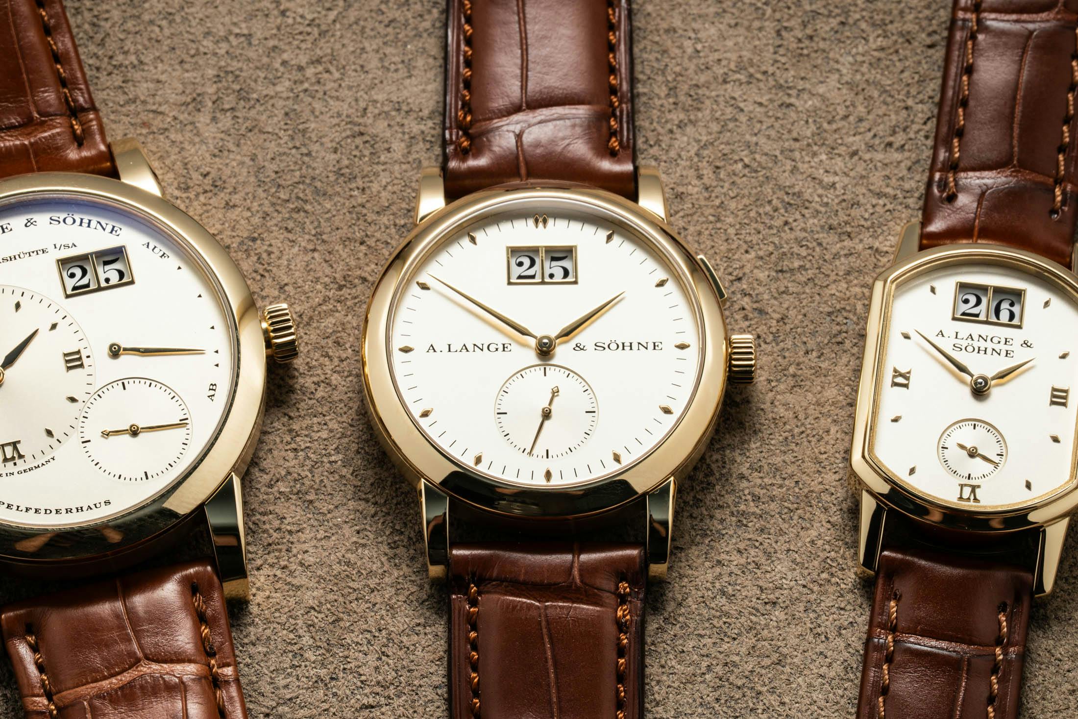 Lange Saxonia Yellow Gold Closeup within a Trio of watches