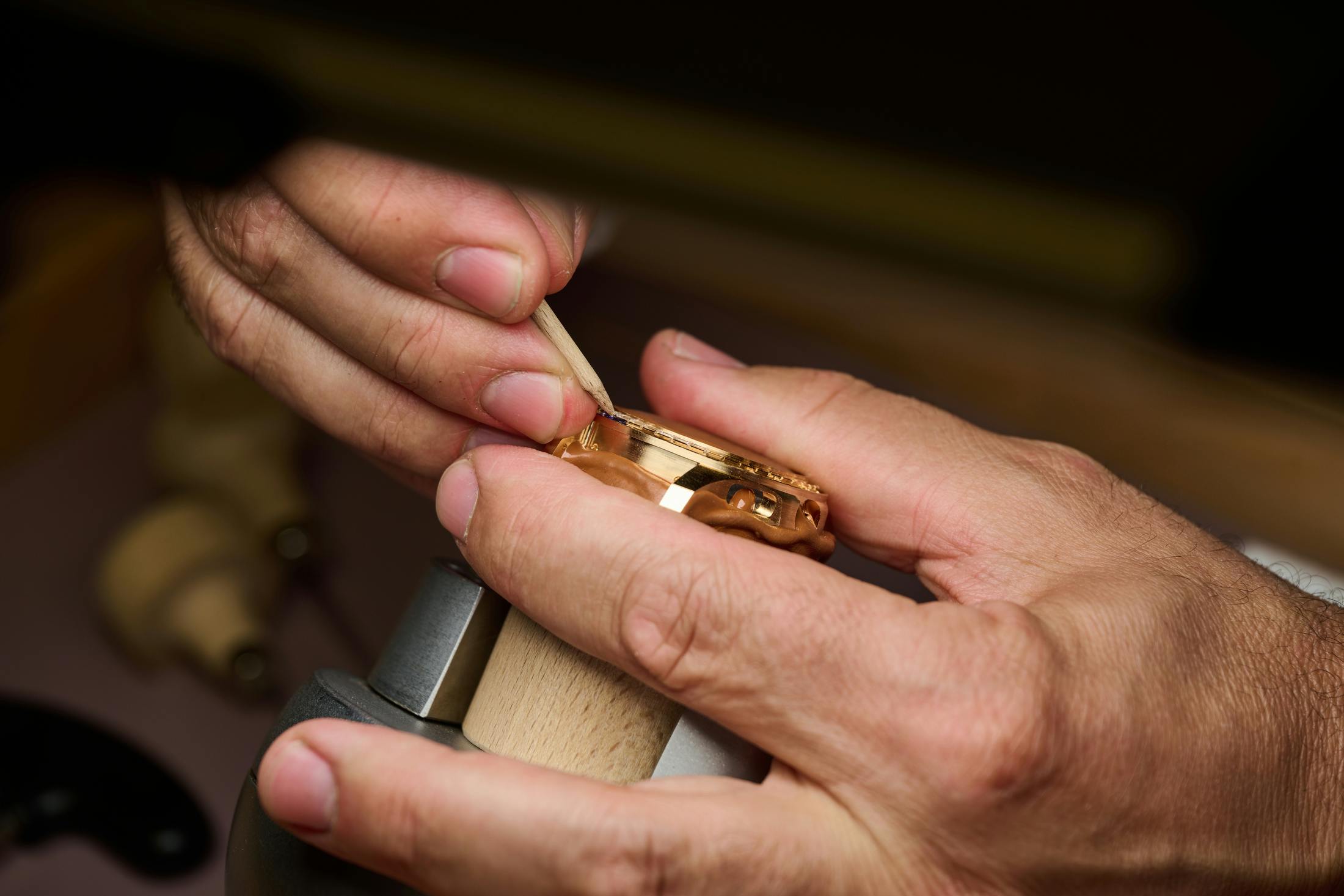 <p>Setting the stone into place and adjusting it with a piece of wood.</p>